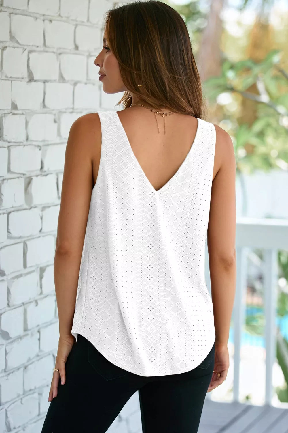 White eyelet knit V-neck tank top with a curved hem.