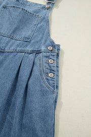 Denim wide-leg jumpsuit with button details and pleats.