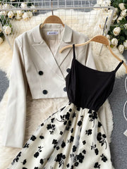 Black floral overlay midi dress with spaghetti straps paired with a cream double-breasted blazer.