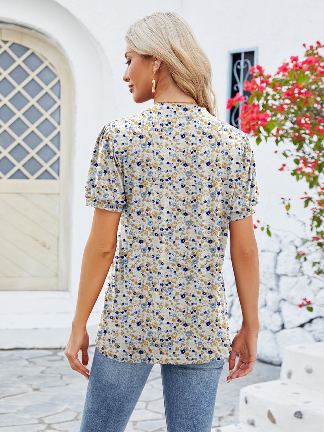 Floral print blouse with short puff sleeves and keyhole neckline, in a multicolor floral pattern.