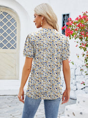 Floral print blouse with short puff sleeves and keyhole neckline, in a multicolor floral pattern.