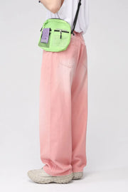 Faded pink wide-leg denim trousers with a relaxed fit, shown on a model.