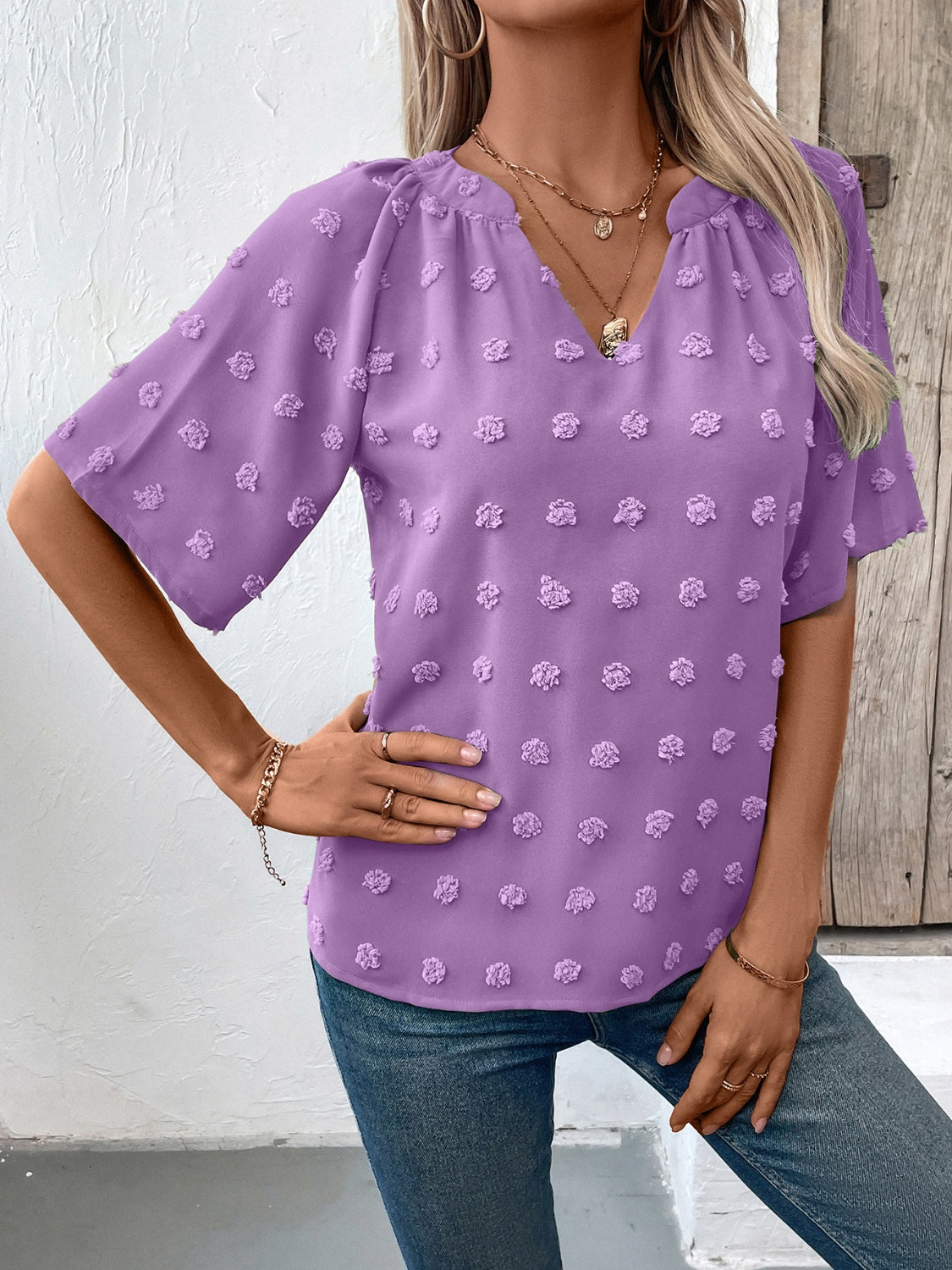 Heliotrope purple Swiss dot blouse with short sleeves and a V-neckline.