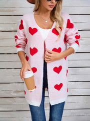 Pink acrylic heart intarsia knit cardigan with white trim and open front.