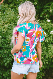 Abstract print blouse with ruffle sleeves in Aqua, pink, orange, and white.