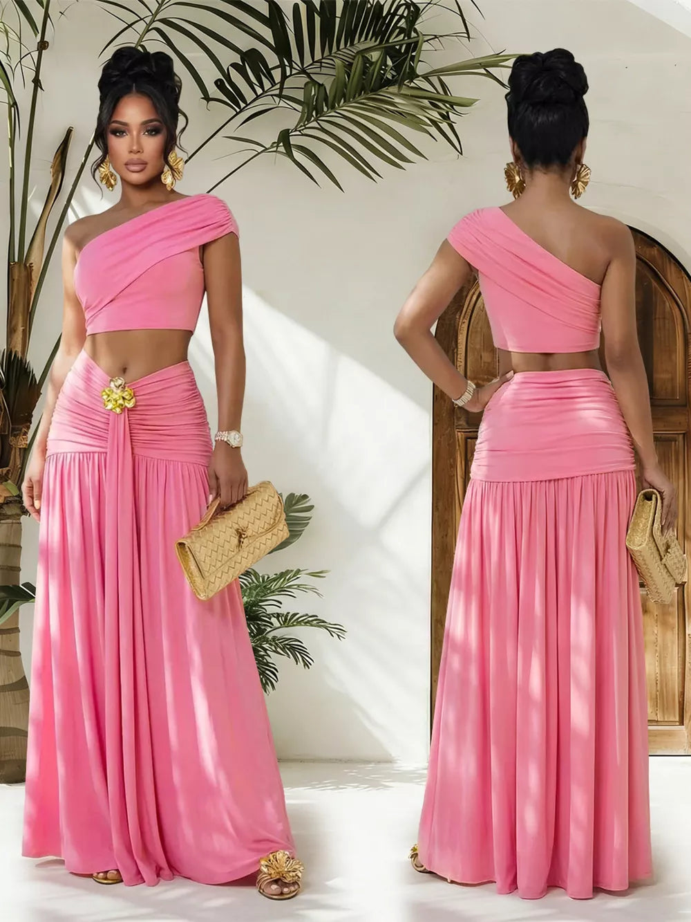 Pink one-shoulder ruched crop top and maxi skirt set with gold accent detail.
