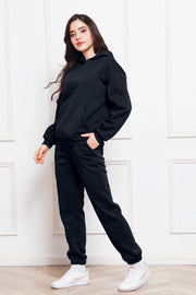 Black relaxed fit hoodie with front pocket and matching joggers with cuffed ankles.