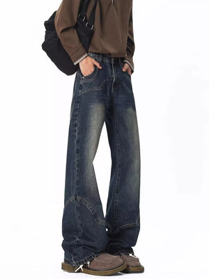 Men's vintage wash wide leg jeans with distressed detailing and a relaxed fit.