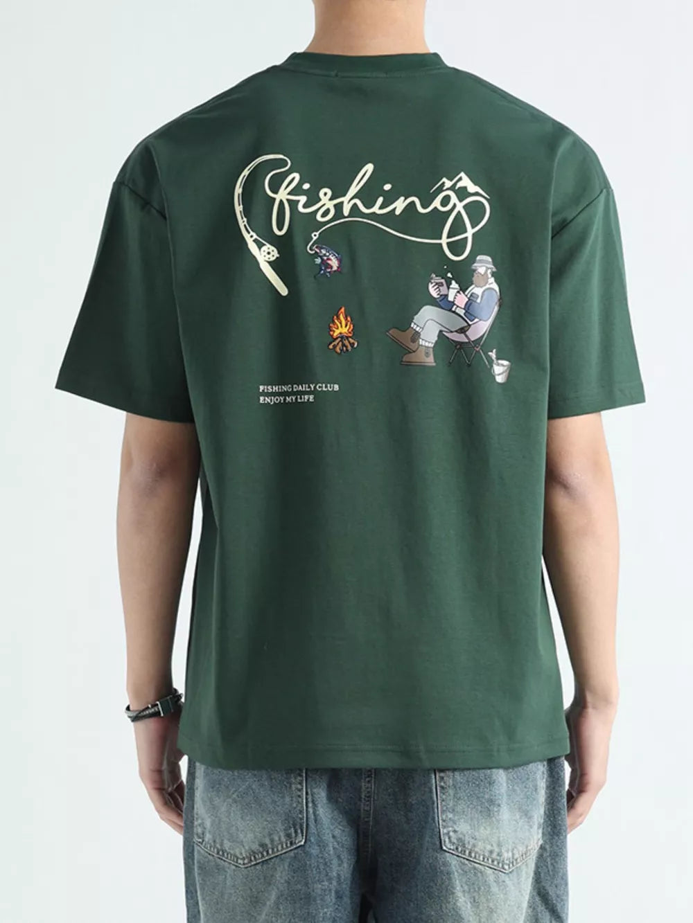 Men's dark green cotton graphic tee with fishing scene and text.