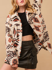 Beige sherpa overshirt jacket with bold Aztec print, button front and chest pockets.