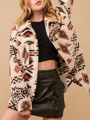 Beige sherpa overshirt jacket with bold Aztec print, button front and chest pockets.