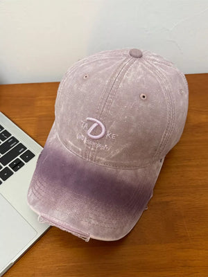 Purple distressed denim baseball cap with embroidered detail and frayed brim.