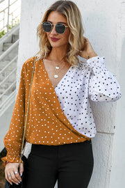 Colorblock polka dot wrap blouse in tangerine and white with smocked cuffs.