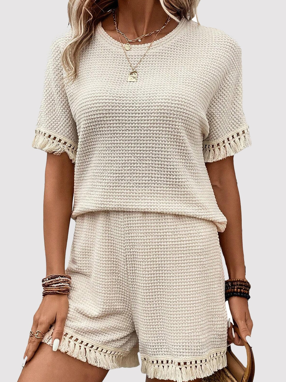 Cream waffle knit set with fringe trim shorts and short sleeve top.