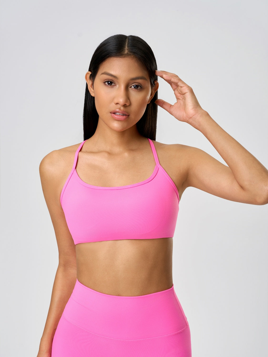 Strappy back active crop top in fuchsia pink with a scoop neckline.