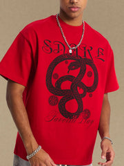 Red oversized tee with black serpent graphic and text.