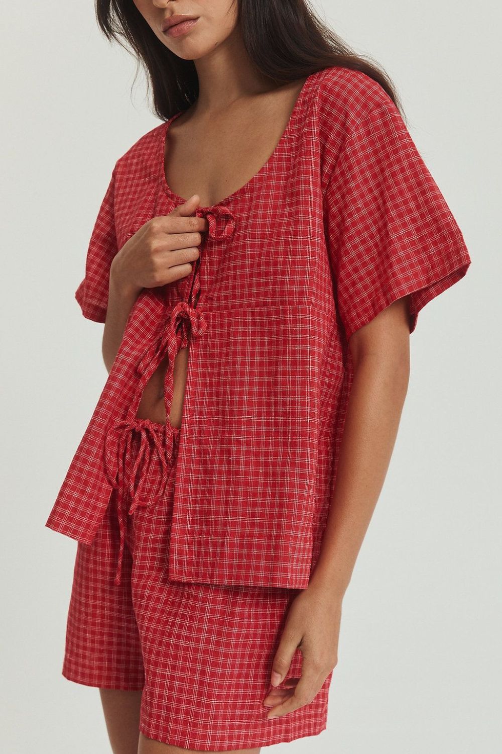 Deep red plaid cotton open-front top with tie closure and matching shorts.