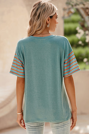Turquoise raglan tee with orange striped sleeves and side slits