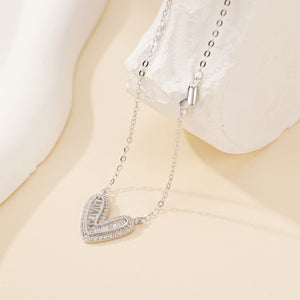 Silver heart pendant necklace with baguette crystals on a delicate chain.