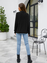 Black textured mock neck knit sweater with long sleeves.