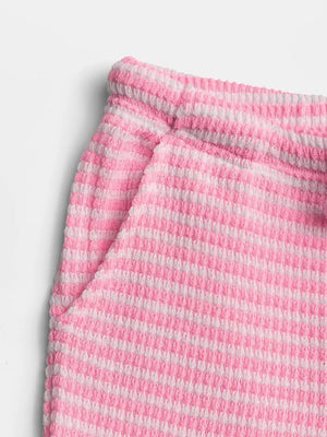 Pink striped maternity wide leg pants with textured fabric and pocket detail.