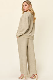 Textured loungewear set in taupe with wide leg pants and crewneck sweatshirt.