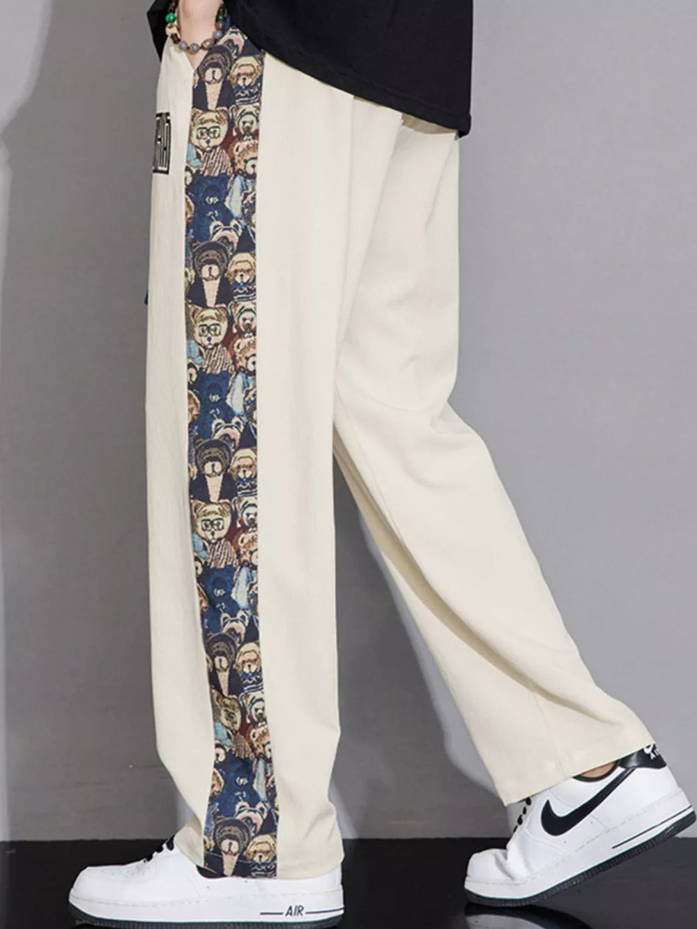 Men's eggshell sweatpants with graphic side stripe detail and drawstring waist.