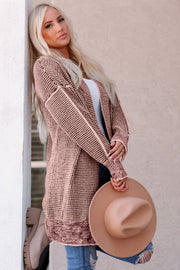Pink textured knit open cardigan with puff sleeves and ribbed cuffs.
