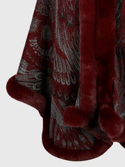 Wine feather print cape with faux fur trim and pom poms.