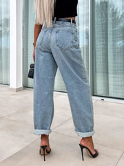Baggy light wash denim barrel leg jeans with cuffed hems.
