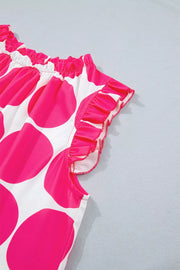 Polyester tank top with pink polka dots and ruffled trim.