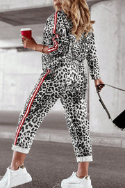 Leopard print joggers with red and white sporty side stripes.