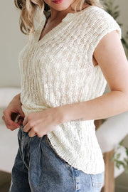 Beige textured knit V-neck shell top with cap sleeves and a relaxed fit.