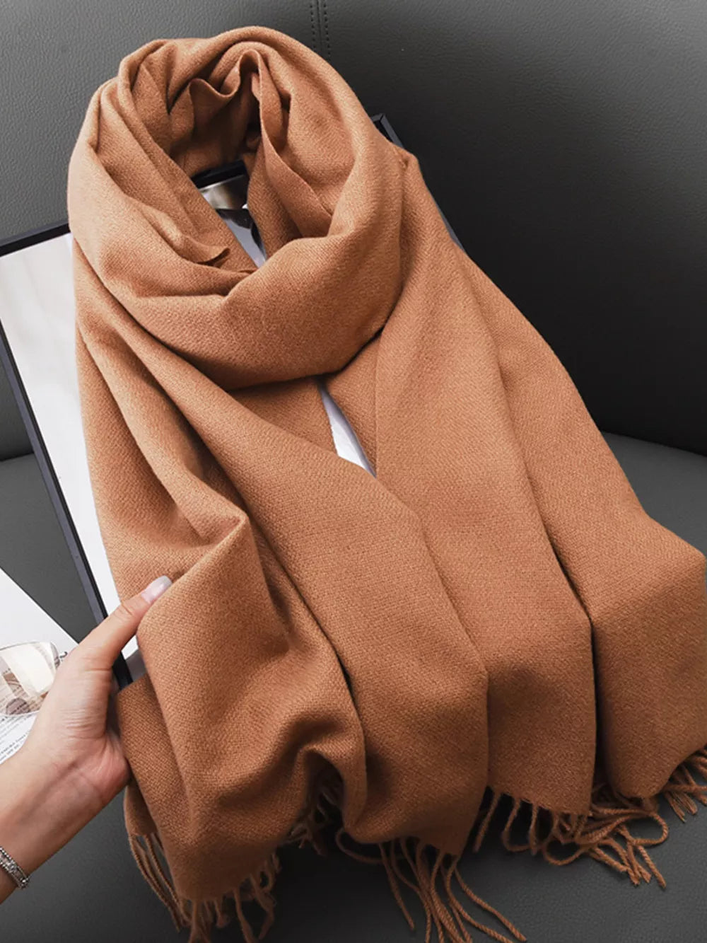 Coffee brown fringed scarf with a soft texture, styled casually.