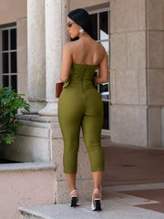 Moss strapless jumpsuit with cinched waist and cropped legs.