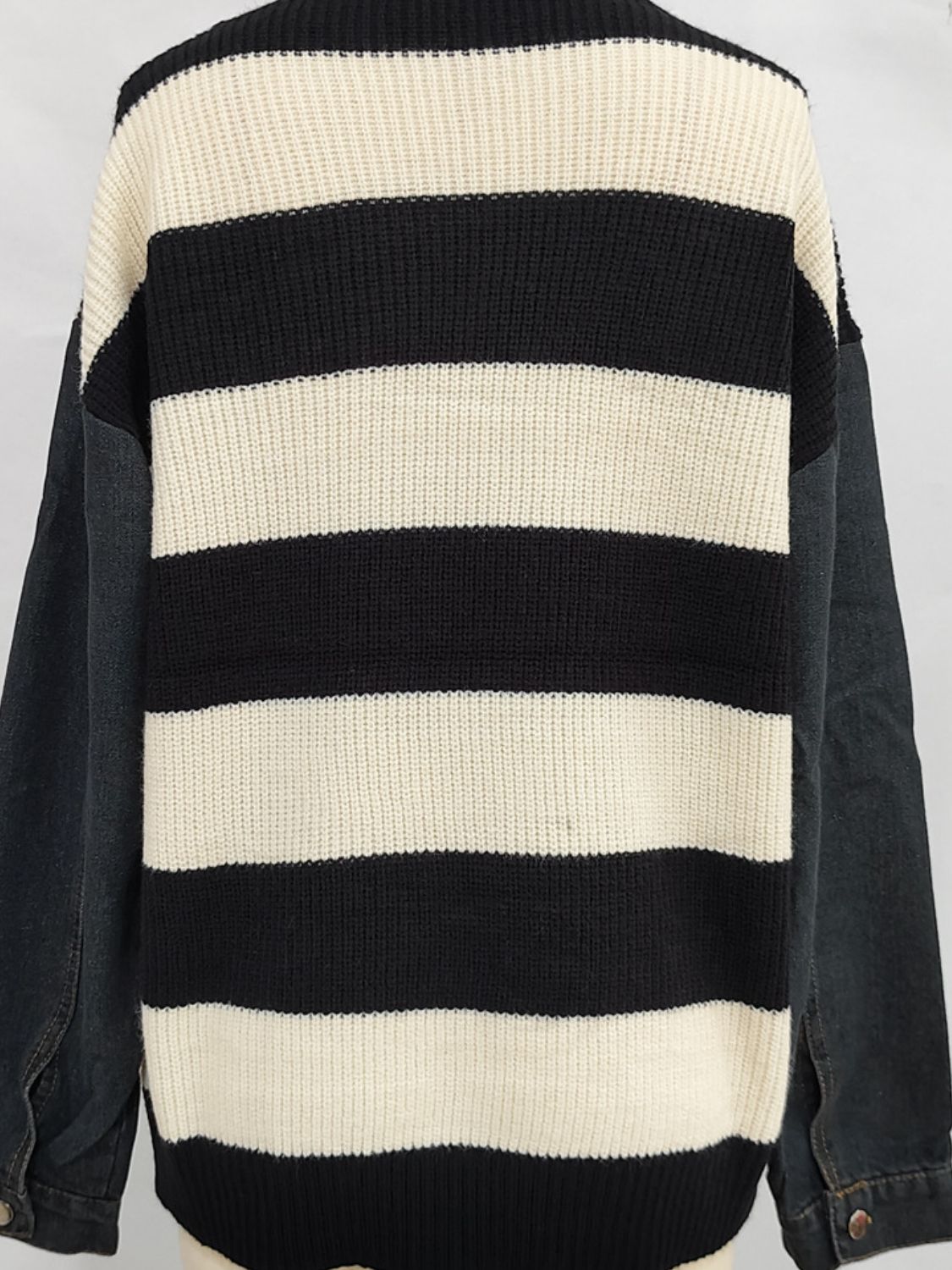 Denim sleeve stripe knit sweater with black and cream horizontal stripes.
