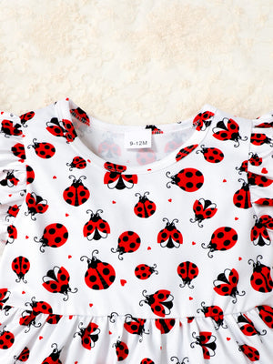 Baby set with white fabric, red ladybug print, and ruffle trim sleeves.