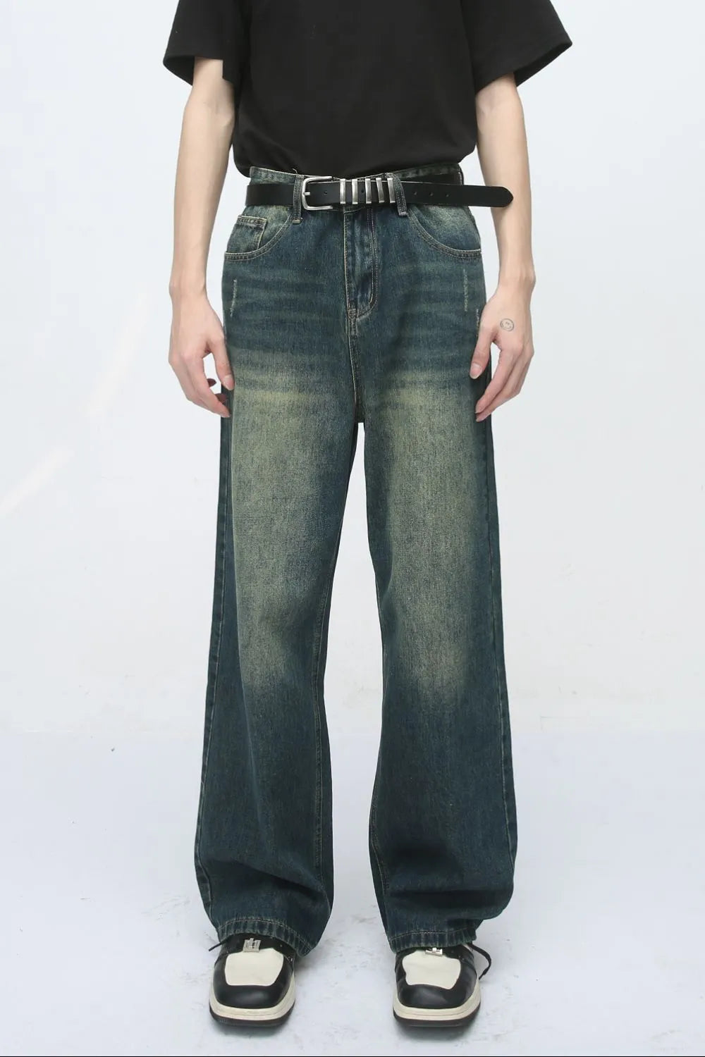 Relaxed fit dark wash denim jeans with pockets and a distressed look.