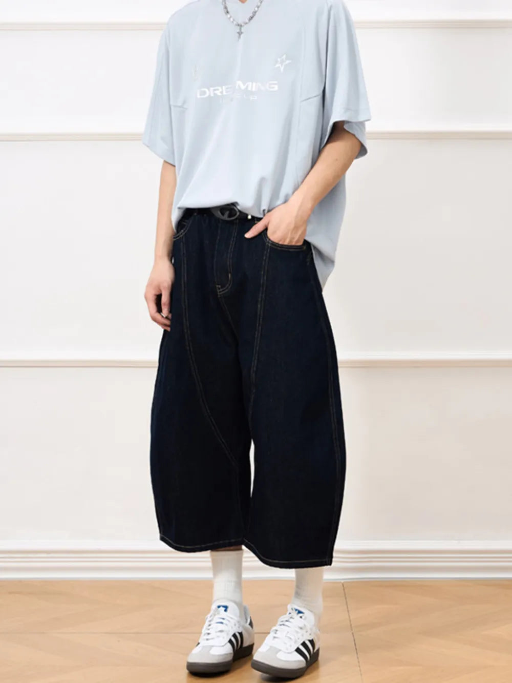 Dark navy cotton denim shorts with a cropped, balloon cut and visible stitching.