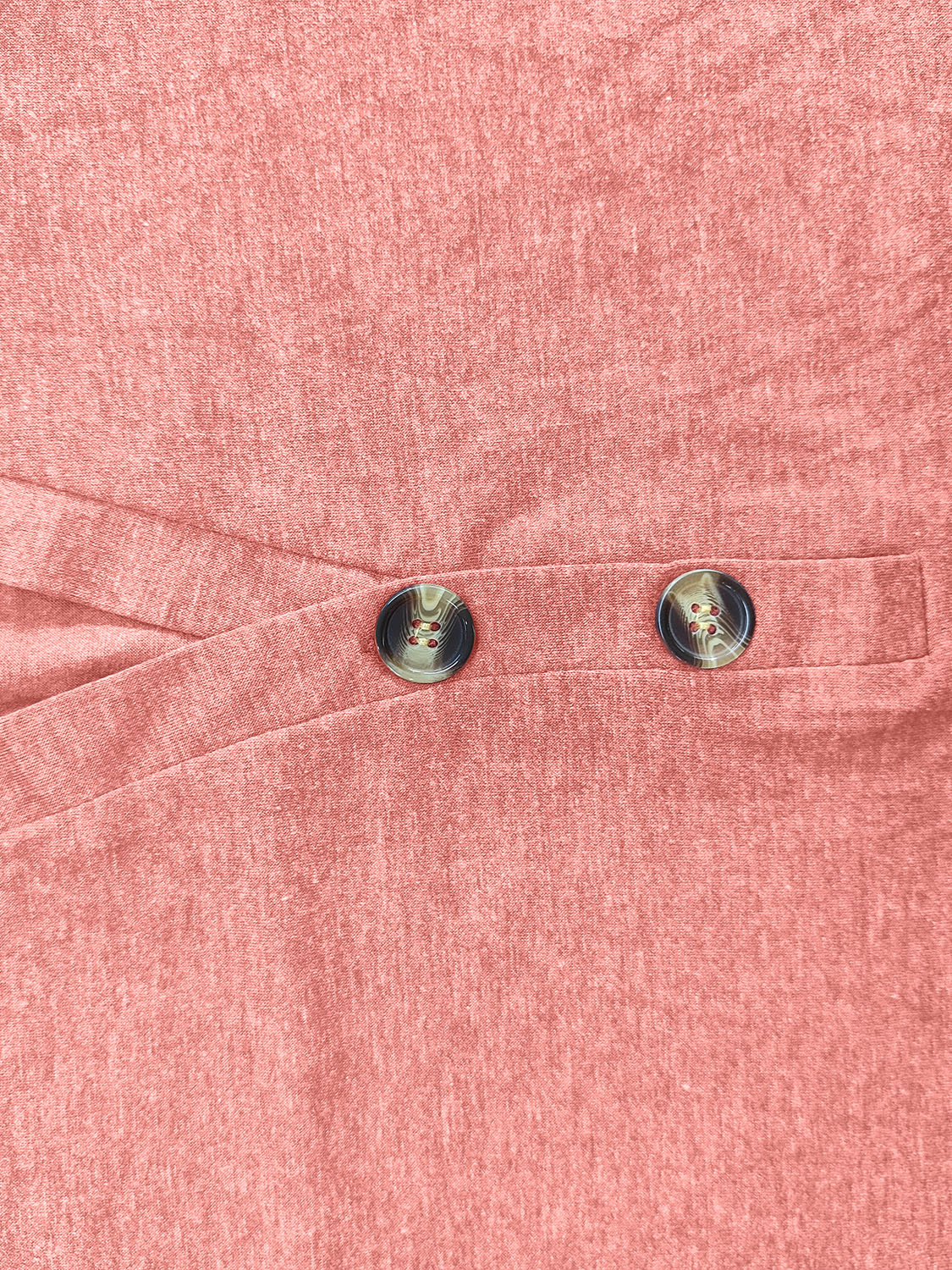 Buttoned henley slouch tee in burnt coral with crossover detail and two decorative buttons.