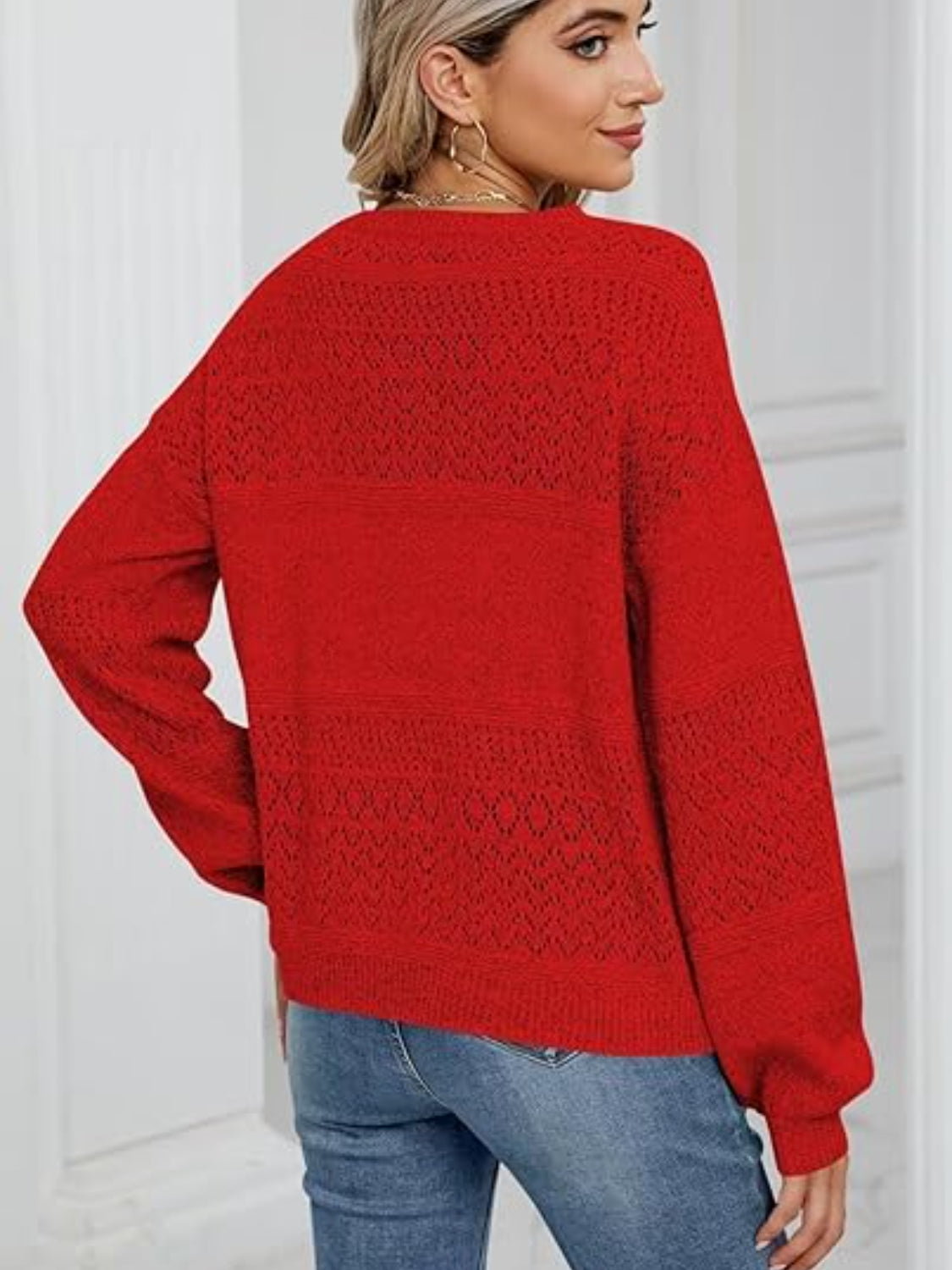 Diamond eyelet knit sweater in deep red with V-neck and long sleeves.