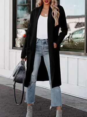 Black relaxed-fit open-front duster cardigan with pockets, styled with a white tank and jeans.