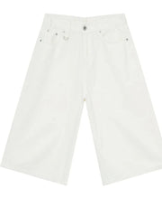 Ivory wide-leg distressed denim culottes with buttoned fly and metal hardware.