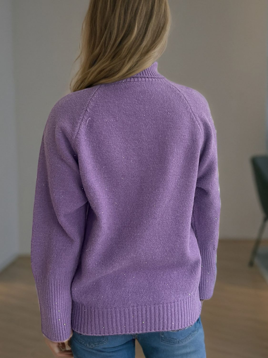 Purple ribbed turtleneck sweater with subtle sparkle detail and cuffed sleeves.