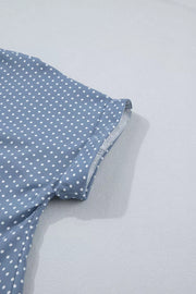 Polka dot short sleeve shirt in blue polyester with cuffed sleeves.