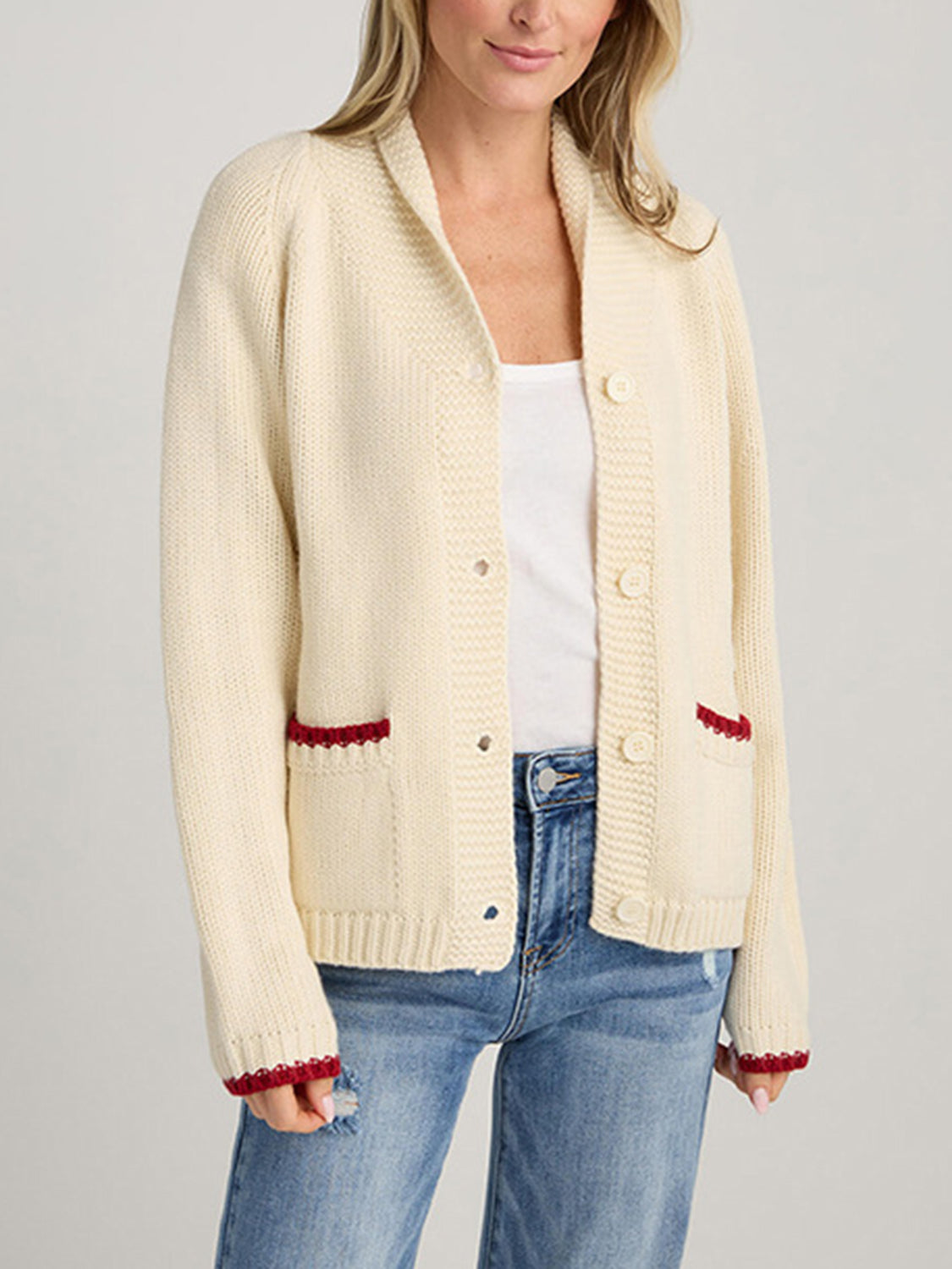 Cream knit cardigan with red trim on pockets and cuffs, button front, shawl collar