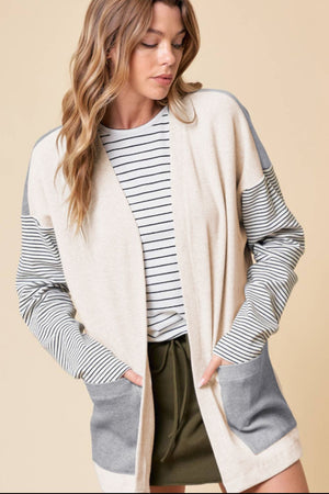 Light gray colorblock cardigan with striped sleeves and pockets, open front, relaxed fit.
