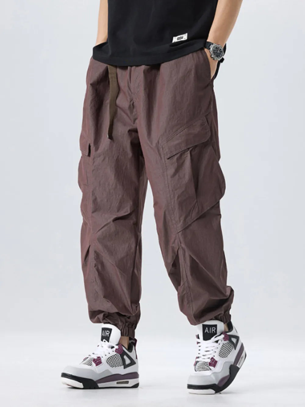 Oversized cargo pants in coffee with adjustable belt and cinched ankles.