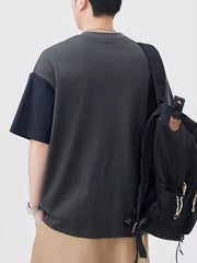 Oversized cotton t-shirt with color block sleeves in dark gray and navy blue.