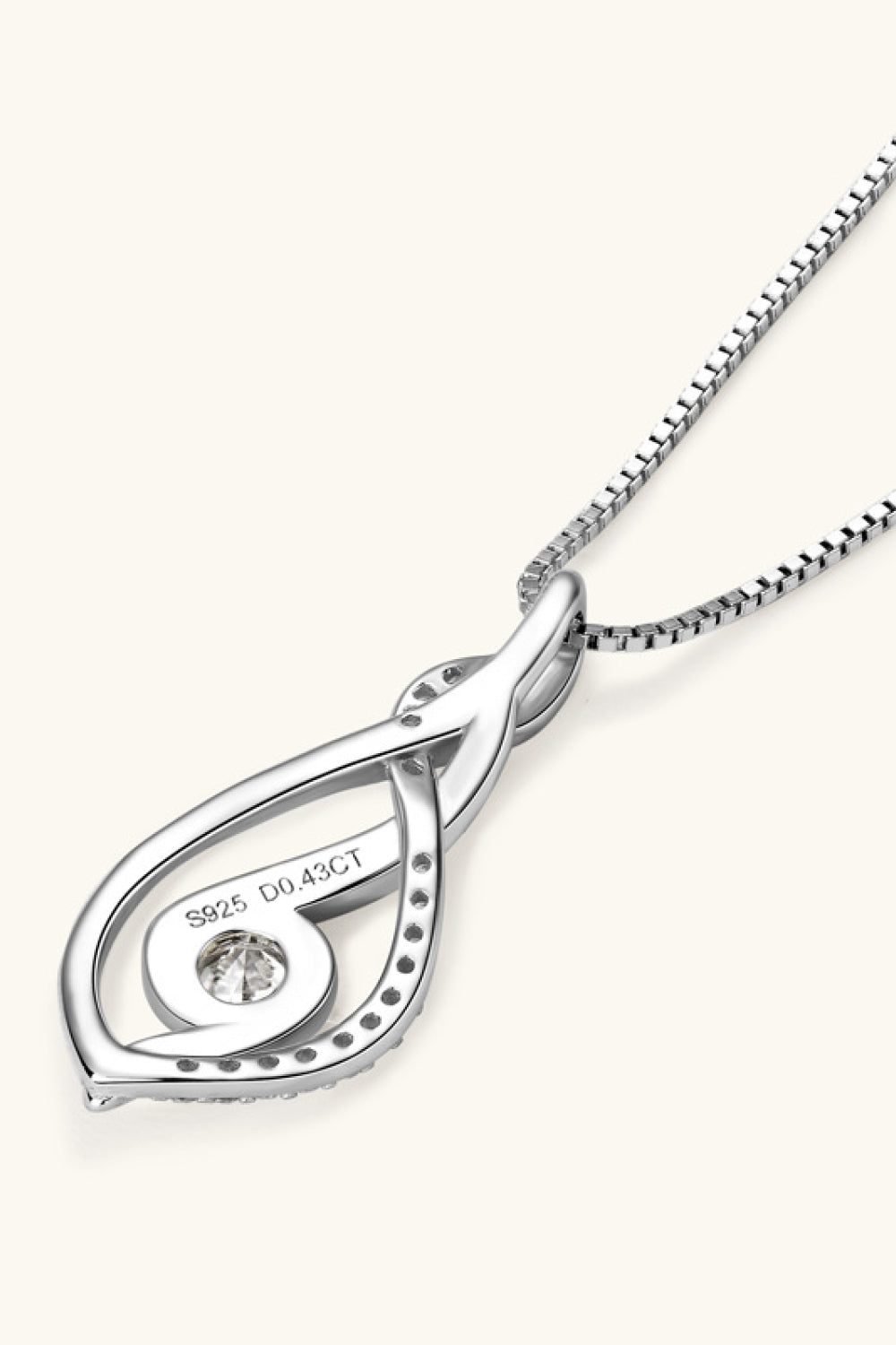 Silver infinity swirl pendant necklace with moissanite and pavé accents.